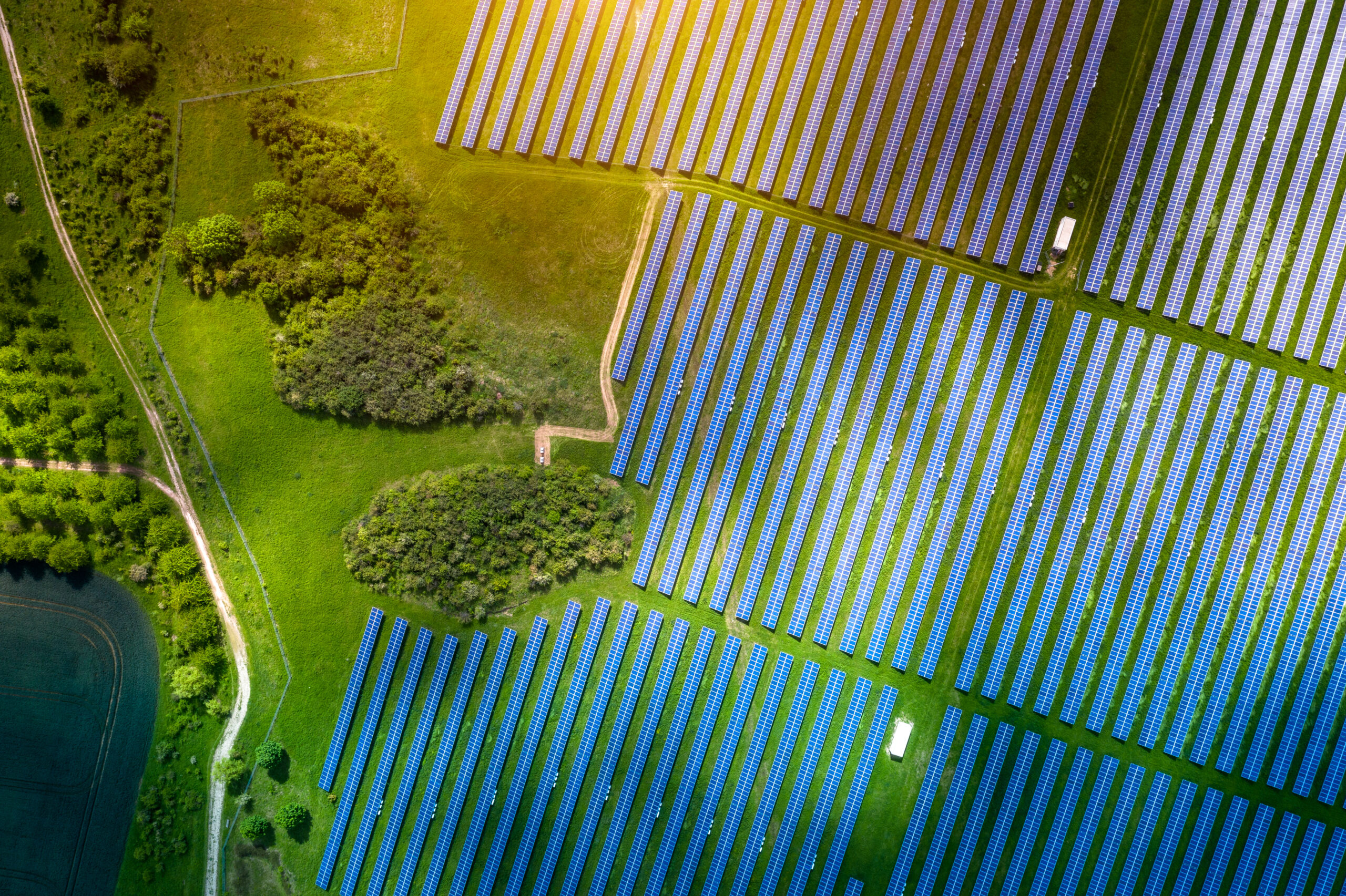 Aerial view over Solar cells energy farm in countryside landscape